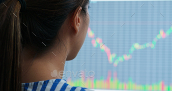 Woman study on the stock market data on computer screen stock photo NULLED
