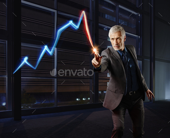 Businessman painting the stock market development with light stock photo NULLED