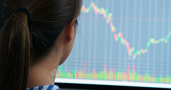 Woman study on the stock market data on computer screen stock photo NULLED