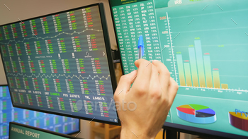Close up of stock market trader hand on monitors stock photo NULLED