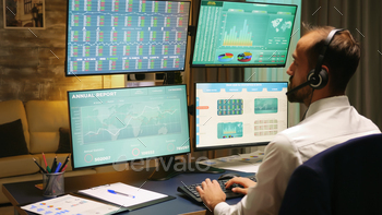 Back view of stock market trader looking at graphs stock photo NULLED