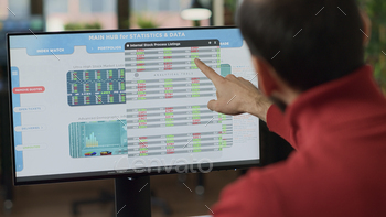 Business investor analyzing stock market trend on monitor stock photo NULLED