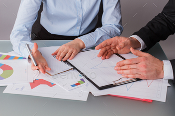 Businessman and businesswoman working to analyses market stock chart. stock photo NULLED