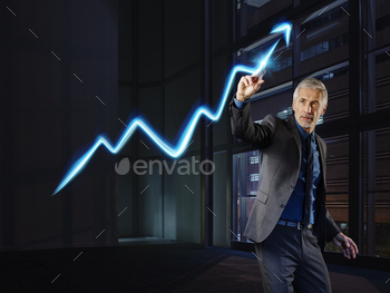 Businessman painting the stock market development with light stock photo NULLED