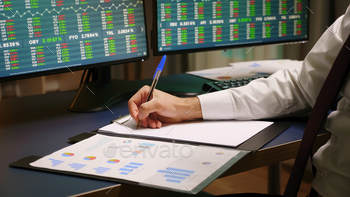 Close up of stock trader taking notes on clipboard stock photo NULLED
