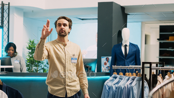 Clothing store assistant checking stock on hologram stock photo NULLED