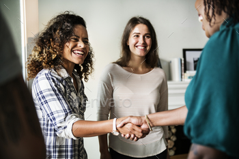 Diverse woman shaking hands stock photo NULLED