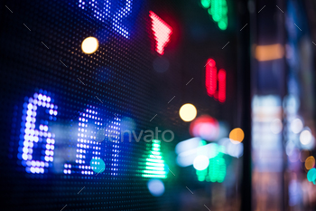 Financial stock market numbers and city light reflection