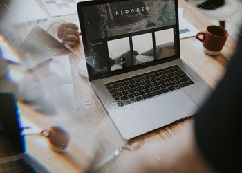 Freelance blogger working on laptop screen mockup stock photo NULLED