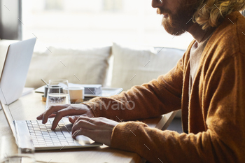 Freelancer Using Computer at Cafe Table stock photo NULLED