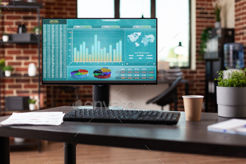 Monitor with stock market analytics in empty business space stock photo NULLED