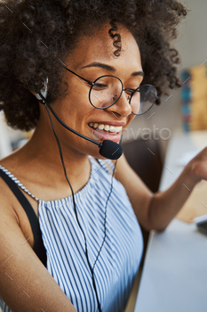 Pleased young freelancer wearing the headphones with a microphone stock photo NULLED