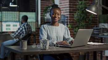Portrait of african american woman working with stock exchange stock photo NULLED