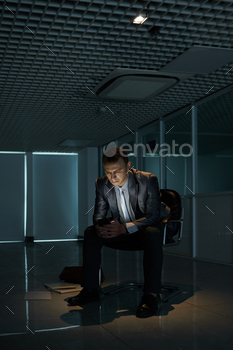 Stressed Businessman Reading News on Stock Market stock photo NULLED