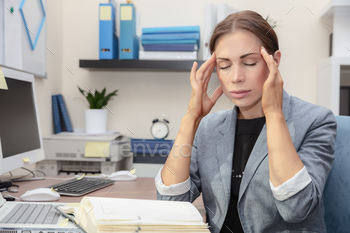 Tired woman at work stock photo NULLED