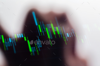 Touching stock market graph on a touch screen device stock photo NULLED