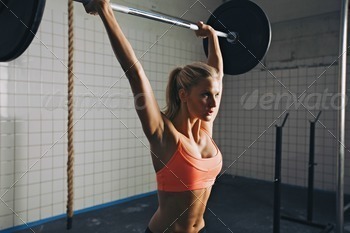 Woman doing crossfit barbell lifting stock photo NULLED