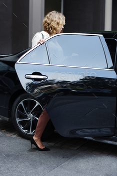 Woman getting into a car stock photo NULLED