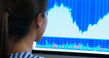 Woman study on the stock market data on computer screen