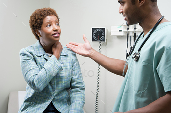 Woman talking to doctor stock photo NULLED