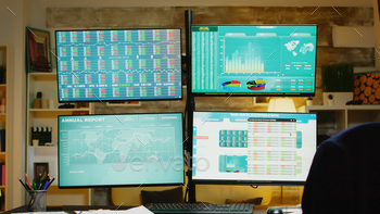Zoom out of home office with monitors for stock market stock photo NULLED