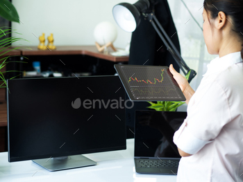 business man holding smart device with stock graph stock photo NULLED