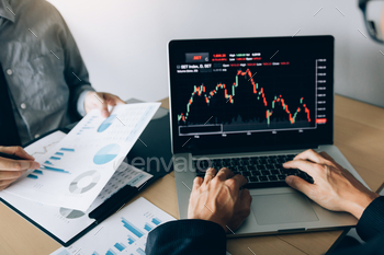 investors are working together with analyzing the stock data graphs stock photo NULLED